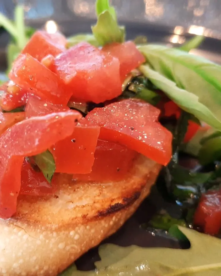 Bruschetta topped with chopped tomato, garlic and basil
