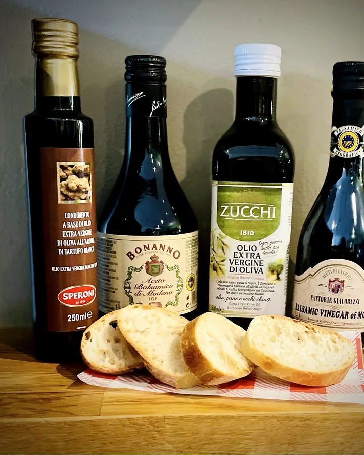 Italian olive oils and balsamic vinegars on the Buono deli shelf with sliced bread